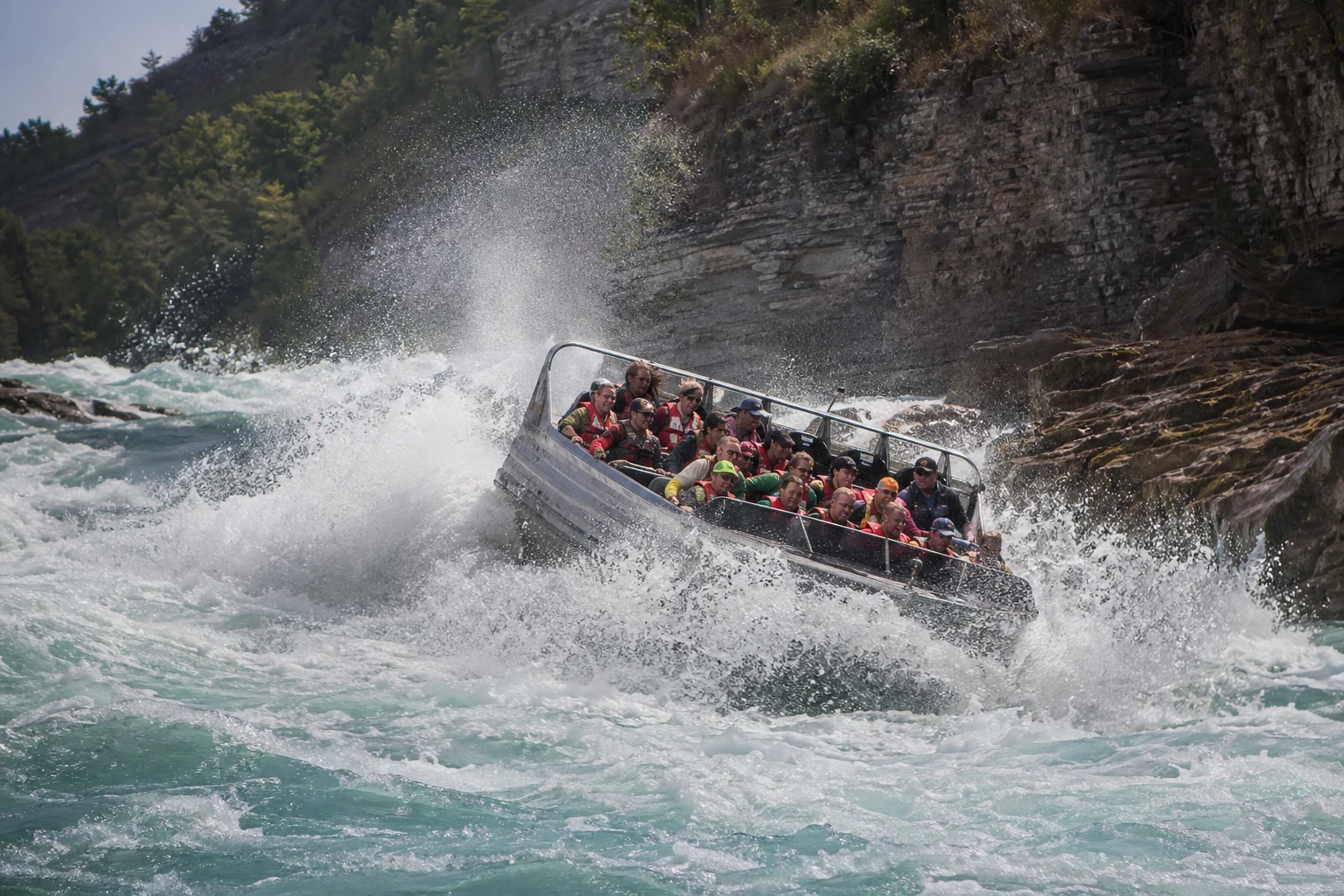 Adventure jet boat in rough Niagara River spray and whitewater